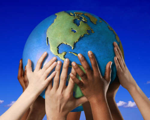 Hands on a globe Hands on a globe --- Image by © Royalty-Free/Corbis